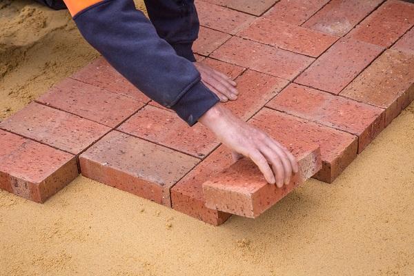 workmen laying bricks